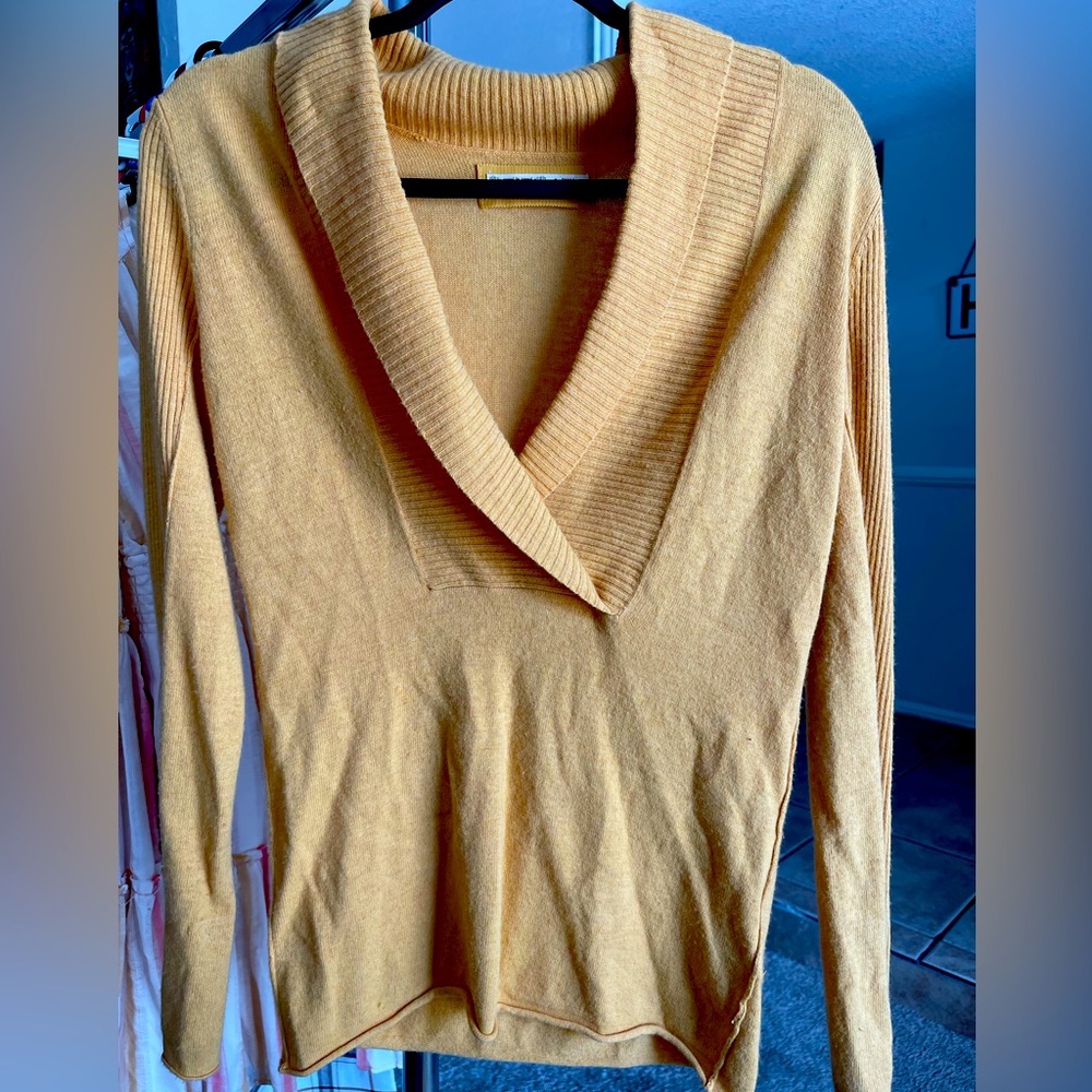 Small light weight sweater. Can be dressy or casual. Very flattering.